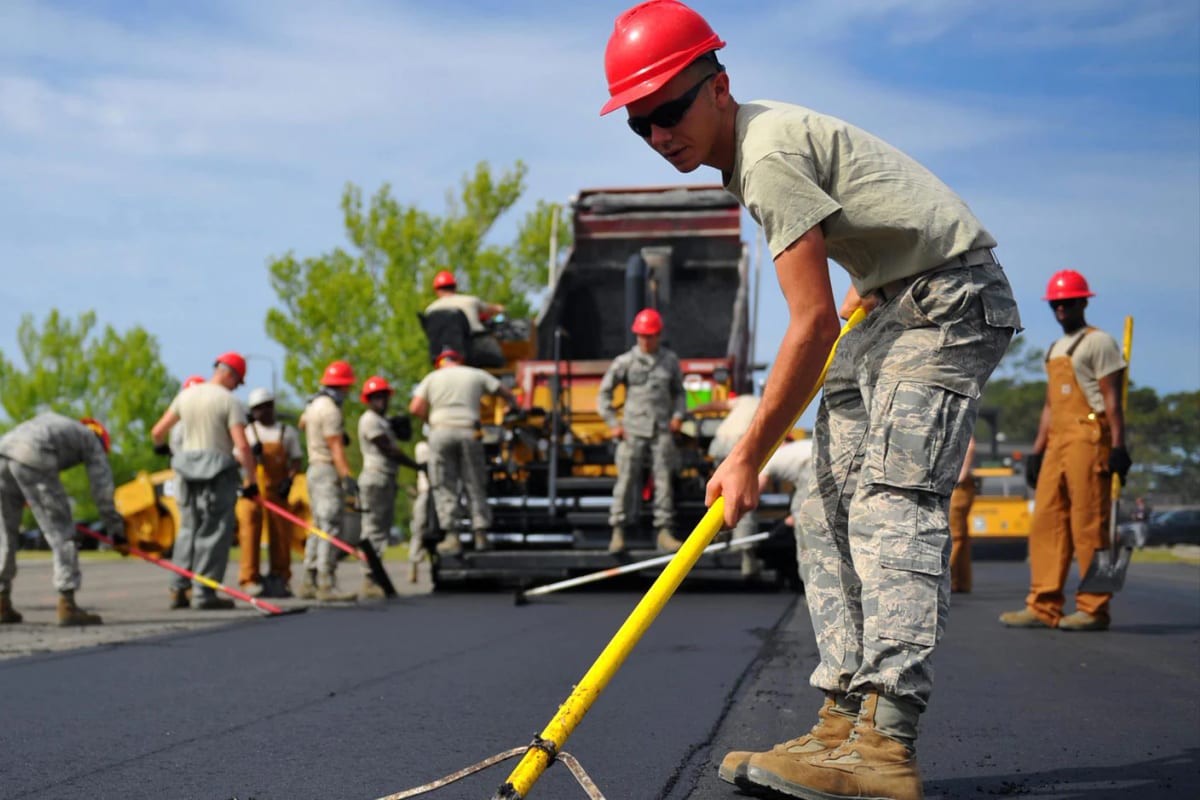 Workers wearing protective equipment on a road construction site